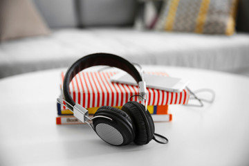 Obraz na płótnie Canvas New headphones on the table in living room