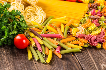 The composition of the pasta and vegetables on a wood background