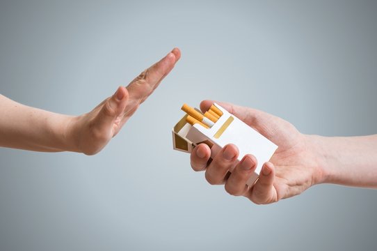 Quitting smoking concept. Hand is refusing cigarette offer.