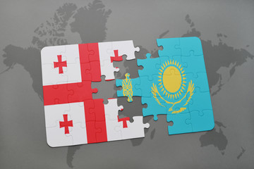 puzzle with the national flag of georgia and kazakhstan on a world map background.