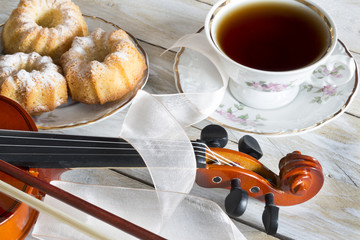Coffee with cupcakes and violin on the wooden table  © sebboy12