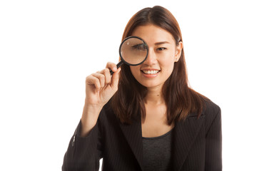 Young Asian business woman with a magnifying glass.