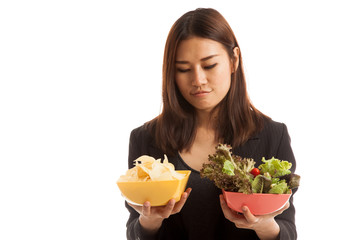 Young Asian business woman with potato chips and salad.