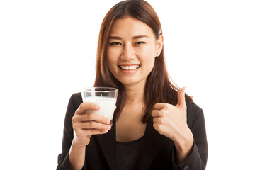 Healthy Asian woman drinking a glass of milk thumbs up.