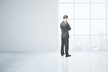 Thoughtful man in empty room