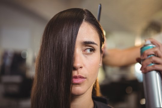 Hairdresser styling customer hair