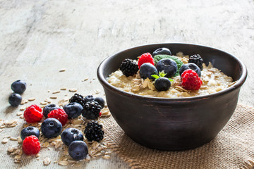 oatmeal porridge in a bowl - obrazy, fototapety, plakaty