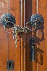 Old brown wooden door handles,chain and lock