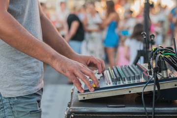 Audio music mixer with dj at the party and audience in background