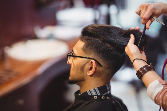 Man getting his hair trimmed with scissor