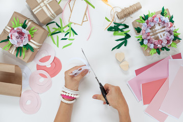 Preparation for the holiday. Packaging of gifts in bright paper.