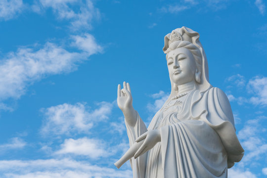 The statue of Guanyin with blue sky and copy space. - Chinese goddess statue (a public temple , can take picture )


