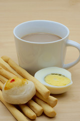 Cup of coffee and grissini, chinese pastry, boiled egg