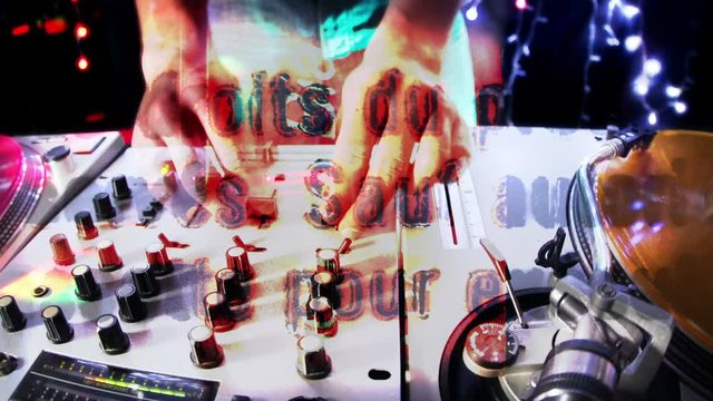 cool male dj behind the turntables