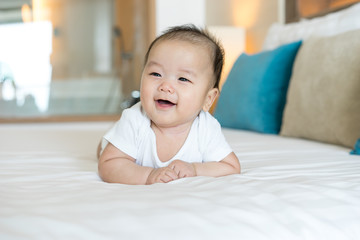 Portrait of a newborn Asian baby on the bed © alice_photo