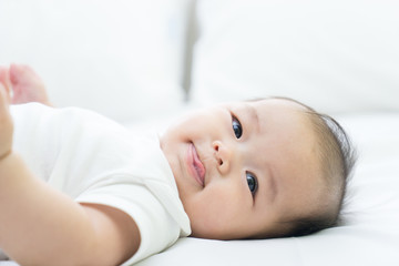 Fototapeta na wymiar Portrait of a newborn Asian baby on the bed