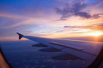 Naklejka na ściany i meble Sunset sky from the airplane window