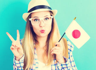 Young traveling woman holding Japanese flag