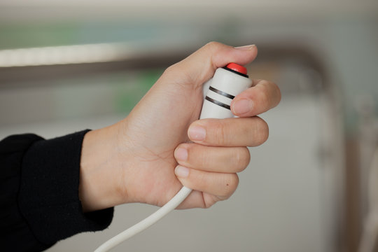 women hand pressing emergency nurse call button