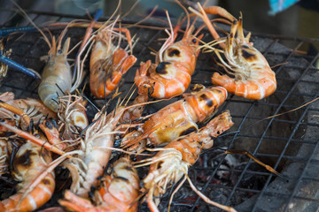 grilled shrimps with flames in background 