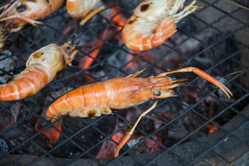 grilled shrimps with flames in background 
