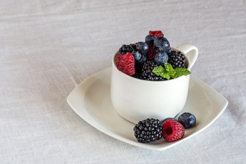 close up of raspberries, blackberries, blueberries and mint leav