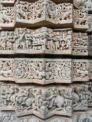 A wall covered in sculpted figures symbolizing different historical events at the 13th Century temple of Somanathapur, Karnataka, South India.