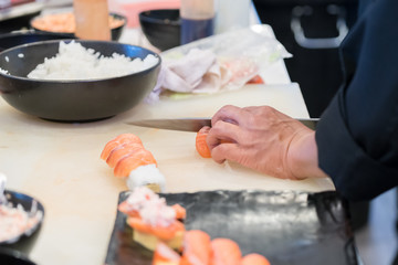 male cooks preparing sushi in the restaurant kitchen
