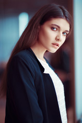 Portrait of beautiful young business woman with model looks in a suit