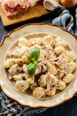 Potato gnocchi, Italian potato dumplings with cheese sauce, ham