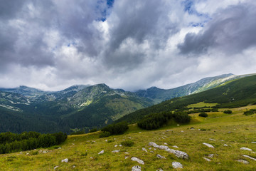 Fototapeta na wymiar Mountain landscape in the Transylvanian Alps in summer, with mist clouds after the rain