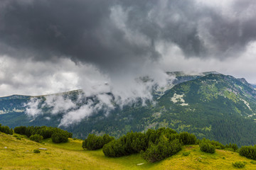 Fototapeta premium Mountain landscape in the Transylvanian Alps in summer, with mist clouds after the rain
