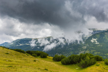 Fototapeta premium Mountain landscape in the Transylvanian Alps in summer, with mist clouds after the rain