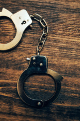 Police handcuffs on investigator detective's work desk