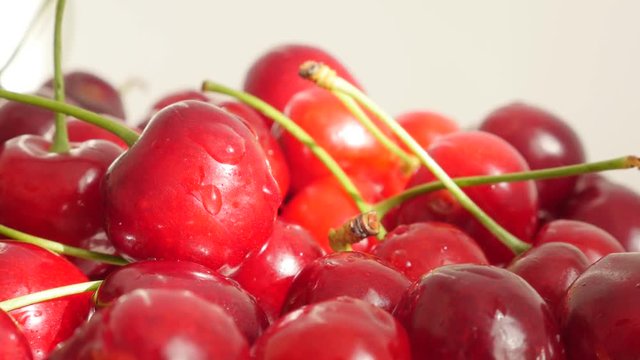 Lot of tart or draft red and fresh cherries pile food background 4K 2160p 30 fps slow tilt UHD video - Prunus cerasus cherry fruit fresh picked with petioles tilting 4K 3840X2160 UltraHD footage 