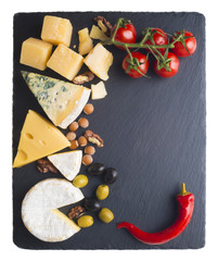 Different varieties of cheese on a black board