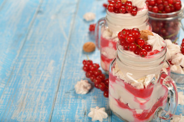 Dessert with red currant and whipped cream