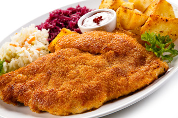 Fried pork chop, baked potatoes and vegetable salad 