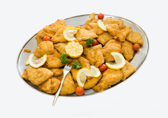 Fried chicken fillets on a tray on  white background.