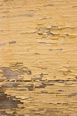 Old woodan wall, shabby yellow paint as background