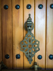 oriental handle on a wooden door