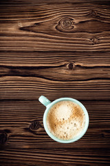 coffee cup on wooden background top view