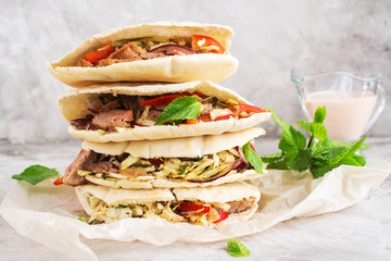 Meat pita bread with yogurt sauce and mint leaves