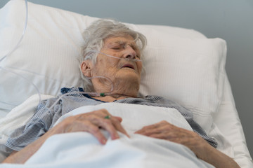 Senior woman lying in hospital bed