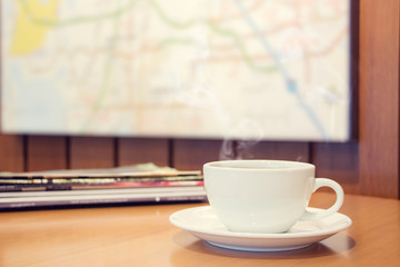Closeup white cup of coffee on wood table.