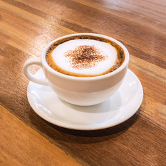 Closeup white cup of coffee on wood table.