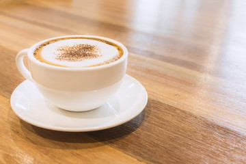 Closeup white cup of coffee on wood table