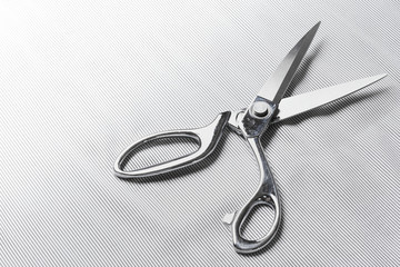 Tailor scissors and cloth with stripes