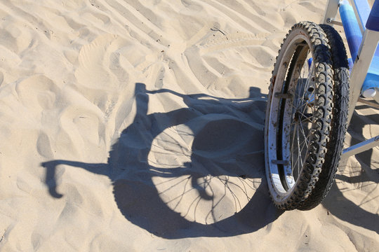 shadow of a wheelchair on the beach
