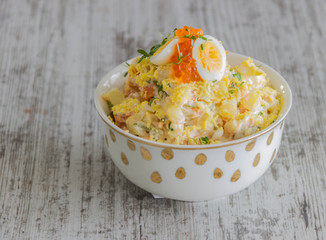 Cod liver salad with eggs, carrots, cheese, onions and potatoes. Salad with sour cream. Mimosa salad